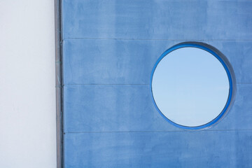 Blue wall background with rounded window 