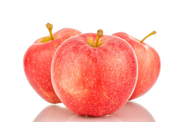 Three ripe red apples, macro, isolated on white background.
