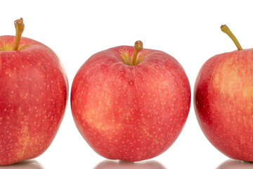 Three ripe red apples, macro, isolated on white background.