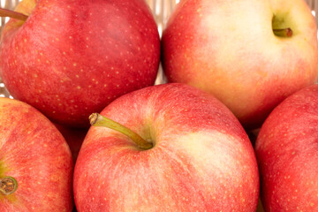 Fototapeta na wymiar Several juicy red apples in a basket, macro.