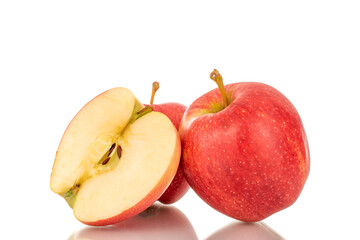 Naklejka na ściany i meble One half and two whole juicy red apples, macro, isolated on white background.