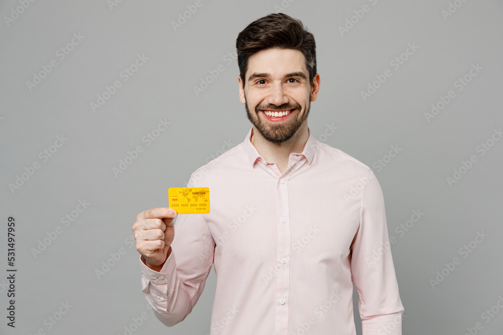 Wall mural young rich smiling happy fun cheerful caucasian man 20s he wear basic white shirt hold in hand mock 