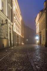 Fototapeta na wymiar Krakow old town, Kanonicza street in the foggy night