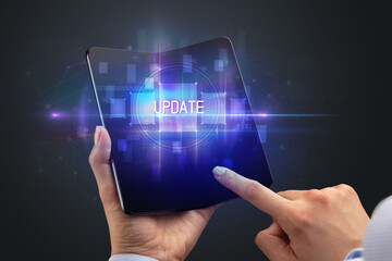 Businessman holding a foldable smartphone