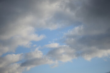 blue sunny sky with round white-black cirrus clouds background texture of the sky in Ukraine gradient white-blue color
