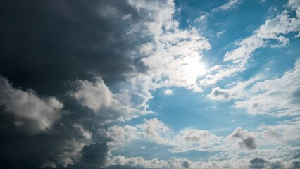 Timelapse gray rainy clouds float across the dark sky on a cloudy day. Cloudy sky and gloomy clouds. Magic dramatic sky in rainy weather. Ominous clouds slowly drift across the sky, threatening rain.