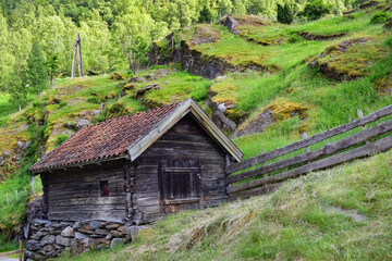 Old wooden shed in hilly landscape