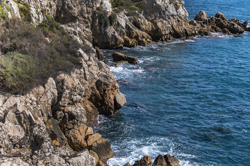 Beautiful Mediterranean coastline under blue sky in Antibes - city on French Riviera between Cannes...