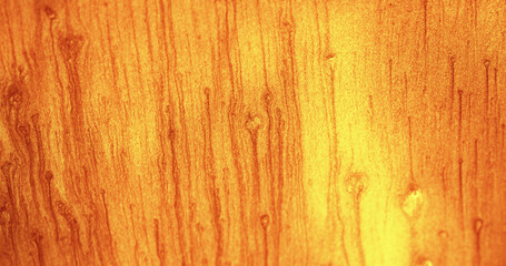 Fototapeta premium Glitter fluid background. Color sand texture. Shimmering sparkles drip. Orange yellow shiny particles abstract copy space wallpaper.