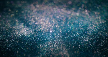Particles background. Bokeh glitter light. Universe nebula. Defocused fluorescent purple blue color sparkles texture on dark abstract wallpaper.