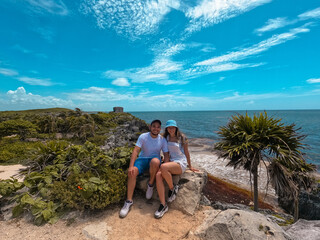 Couple enjoying the archaeological ruins of tulum in the riviera maya