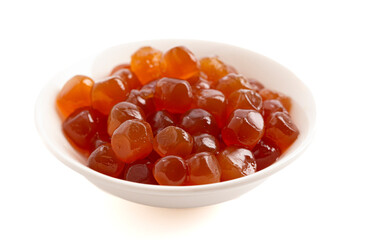 Bowl of Caramel Tapioca Pearl Balls Used in Boba Tea on a White Background