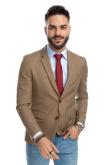 handsome guy holding hand in pocket and smiling