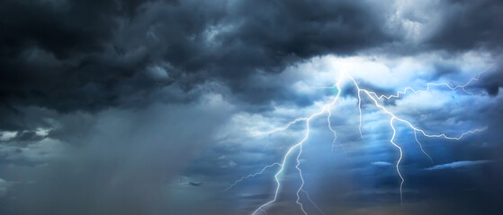 The dark sky with heavy clouds converging and a violent storm before the rain.Bad or moody weather sky and environment. carbon dioxide emissions, greenhouse effect, global warming, climate change. - obrazy, fototapety, plakaty