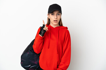 Young sport woman with sport bag isolated on white background thinking an idea pointing the finger up