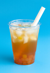 A Passion Fruit Boba Tea on a Blue Background
