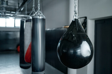 Different punching bag hanging on ceiling