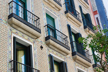 Vintage facade decorated with classical tiles on Fuencarral street, Chueca district, Madrid, Spain