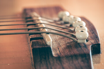Acoustic guitar bridge and strings close up.