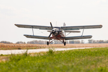 Fototapeta na wymiar Small light airplane ready to flight on the airport field.
