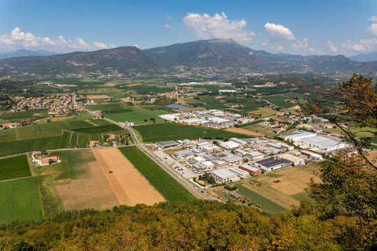 Business parks, villages Albarè Stazione and Gazzoli and vineyards in an areal view from Monte Moscal in the village of Affi, Verona in Italy.