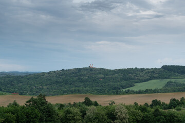 Fototapeta na wymiar Village church on hill against gloomy sky, Saint Anthony church on Topuz hill near Derventa