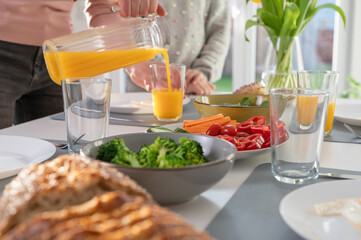 Closeup photo of a woman serving breakfast at home in the morning