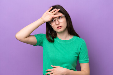 Young pretty Russian woman isolated on purple background With glasses and tired