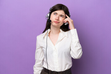 Telemarketer Russian woman working with a headset isolated on purple background having doubts and with confuse face expression