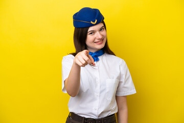 Airplane stewardess Russian woman isolated on yellow background points finger at you with a confident expression