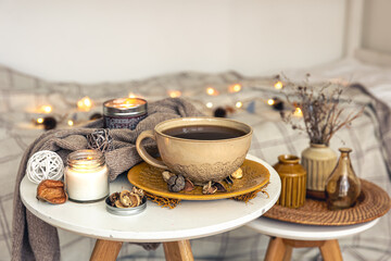Cozy autumn composition with a cup of tea and decorative details.