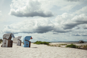 Photo of sunny beach with white sand and beach chair in north Germany