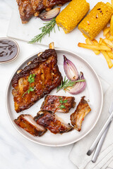 Grilled pork ribs with barbecue sauce and ketchup and grilled vegetables	
