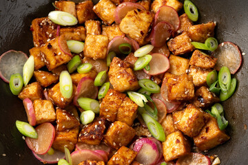 Fried tofu with radish, spring onion and garlic, ginger dressing in wok