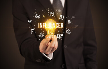 Businessman holding a light bulb, social media concept