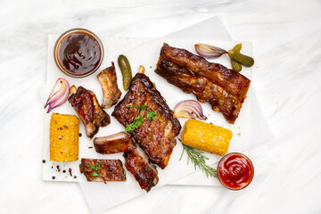 Grilled pork ribs with barbecue sauce and ketchup and grilled vegetables	
