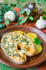 Baked salmon steak with potatoes and parsley