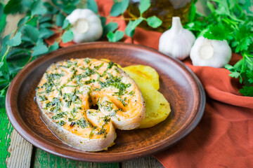 Baked salmon steak with potatoes and parsley