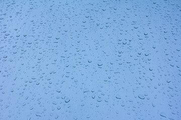 Drops on a blue background close-up, drops on glass background
