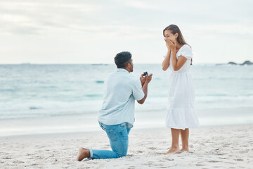 Love, couple and beach engagement proposal for marriage, partnership and commitment on ocean sea...