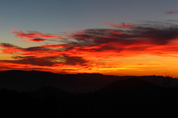 Red and orange sunset with mountains
