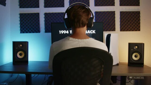 Boy Laying down his PS5 controller and headset then walking away after gaming on his PlayStation 5 in an RGB LED room at night, Wide