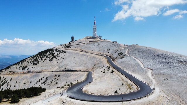 Narrow highway leading to the Mont Ventoux in France with a blue sky in the background