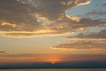 Naklejka na ściany i meble Sunset on Garda lake in Italy in a beautiful summer evening