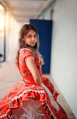 portrait young latin woman looking at the camera dressed with chilean national custome .