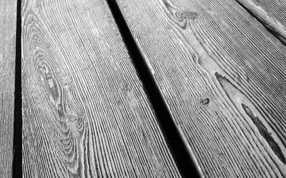 Old wooden floor made of rough oak boards, black and white