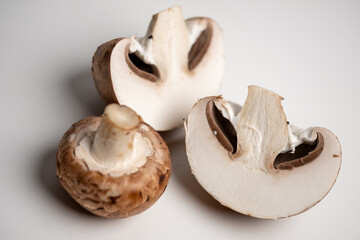 some brown champignons on a white table. meal ingredients. Vegetarian, vegan food. healthy diet. food background.