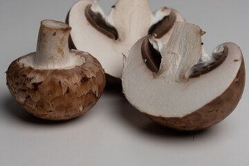 some brown champignons on a white table. meal ingredients. Vegetarian, vegan food. healthy diet. food background.