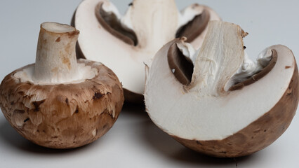 some brown champignons on a white table. meal ingredients. Vegetarian, vegan food. healthy diet. food background.