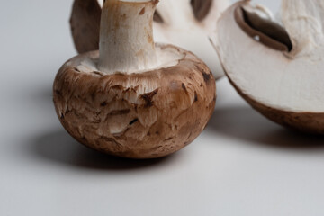 some brown champignons on a white table. meal ingredients. Vegetarian, vegan food. healthy diet. food background.